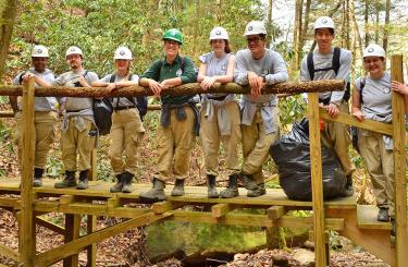 volunteers standing on bridge