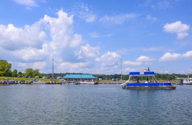 double decker pontoon boat leaving marina