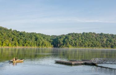 calm day with fishing boat on lake